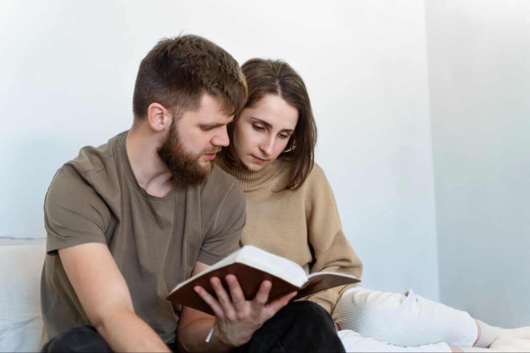 a catholic couple reading a bible together